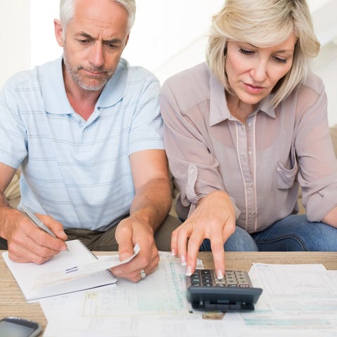 Older couple looking at documents and using a calc