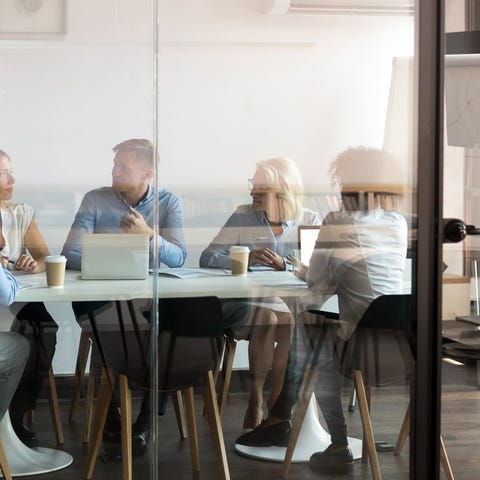 A boardroom meeting in a contemporary, casual work