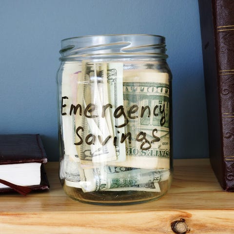 Glass labeled emergency savings jar filled with bi