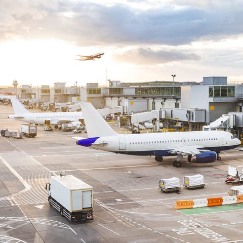 A busy airport with planes parked at the terminal.