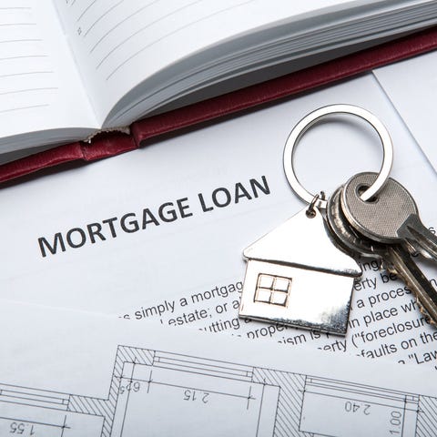 House keys on top of mortgage loan documents.