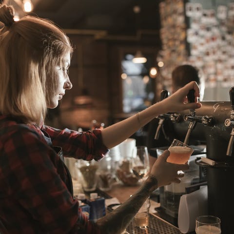 Bartender pouring a beer from a tap
