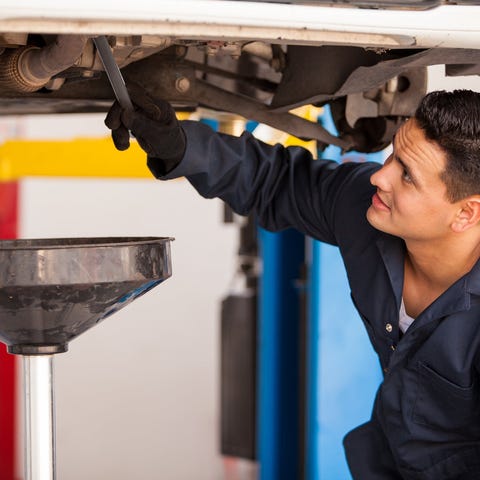 A man performing car maintenance