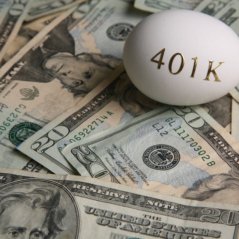 401k egg on top of twenty dollar bills.