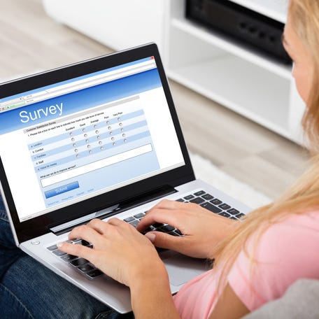 Woman taking an online survey on a laptop