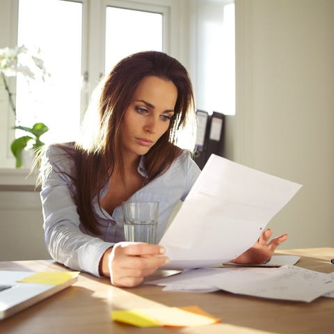 A woman looking at financial documents in front of