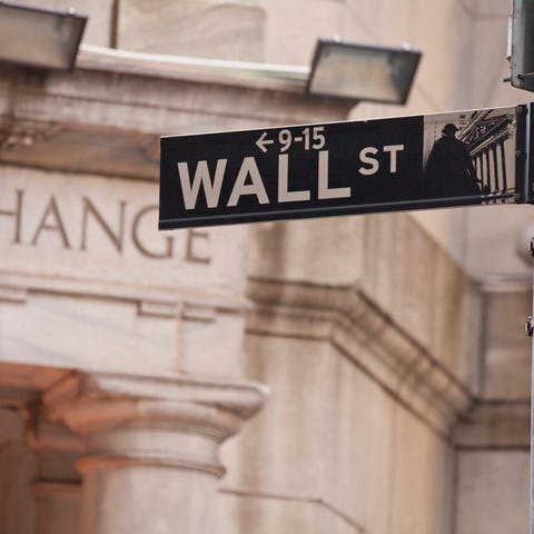 The Wall Street sign post with the New York Stock 