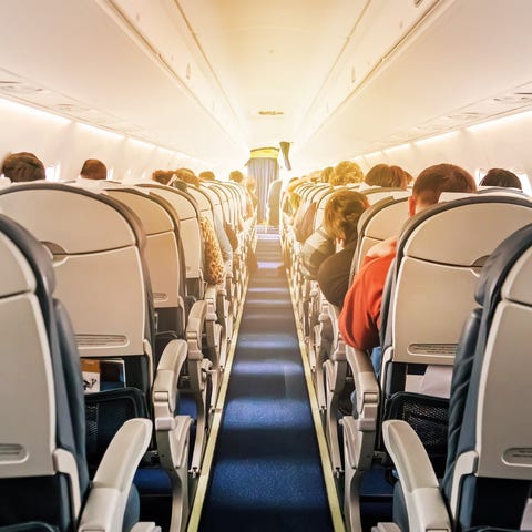 Passengers sitting inside a plane.