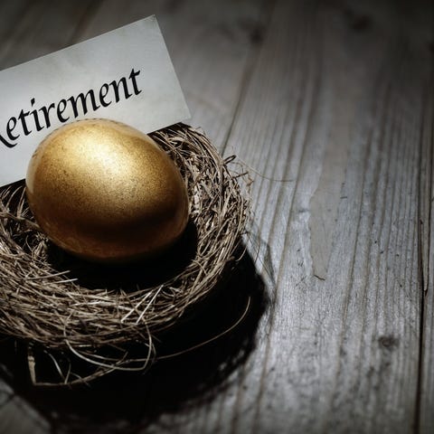 Golden egg in a nest with the word retirement