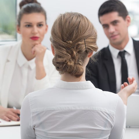 Woman at a job interview with two interviewers.