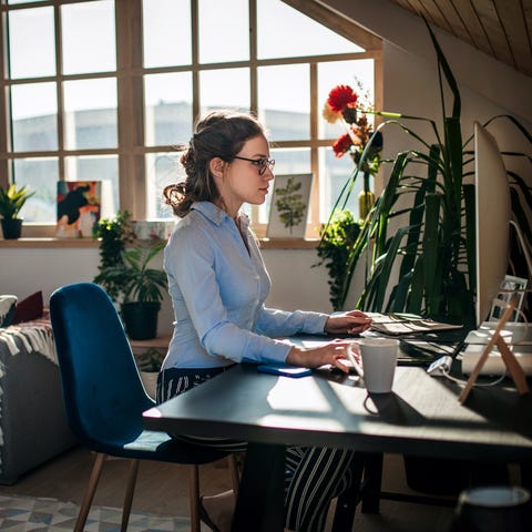 Woman working at computer in her living room