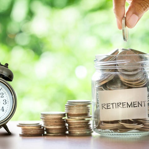 Jar labeled "Retirement Savings" with clock and co