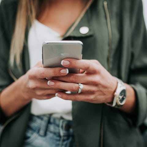 A woman uses a smartphone.