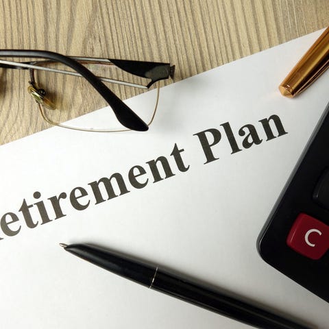 A piece of paper with words retirement plan writte