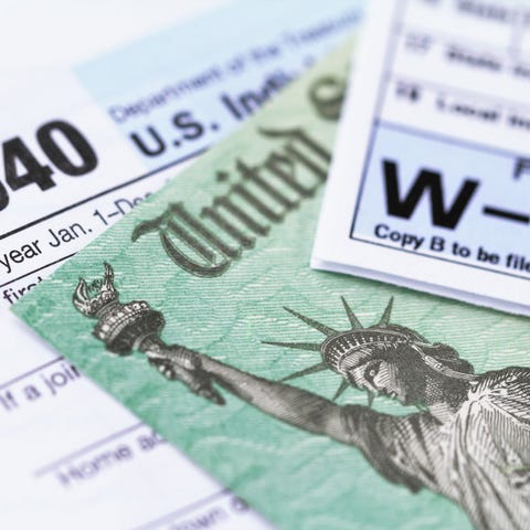 IRS tax forms with tax refund check.