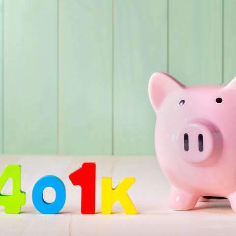 Piggy bank with colorful 401(k) letters next to it