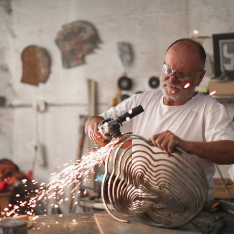 Retirement aged man metalworking