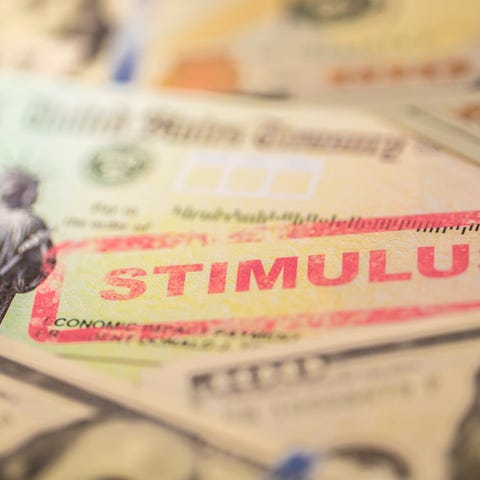 Stimulus check with hundred dollar bills