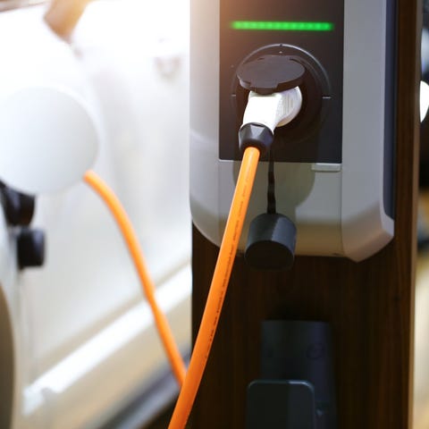 An electric vehicle plugged into a charging statio