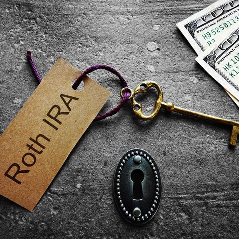 Gold key with Roth IRA tag, with keyhole and cash.