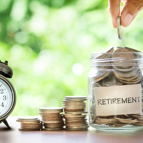 Jar filled with coins labeled retirement.