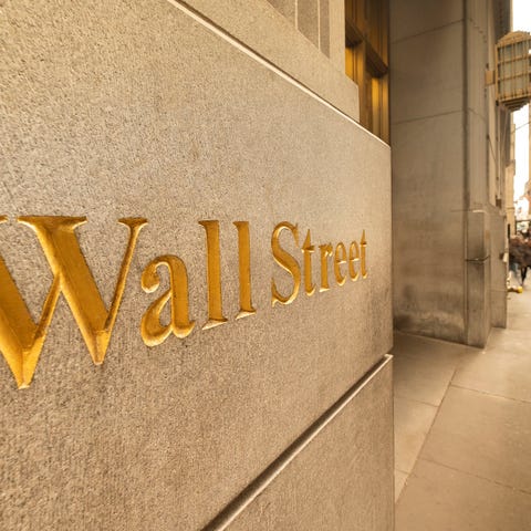 The words, Wall Street, engraved into the side of 