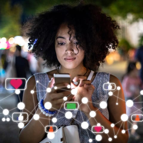 A smartphone user accesses social networking apps.