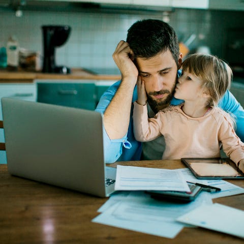 Stressed person looking at documents with small ch