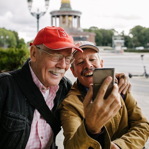 Two adults taking selfie at tourist attraction.