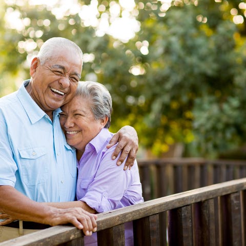 Two people standing outside and hugging.