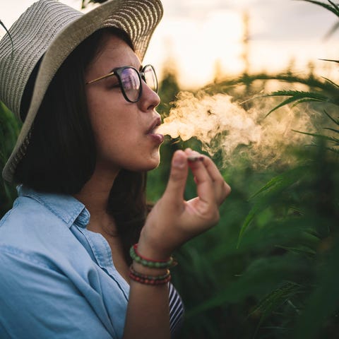 Person smoking a marijuana cigarette in a cannabis