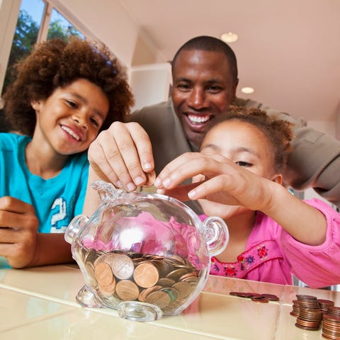 A family saves coins in a piggy bank.