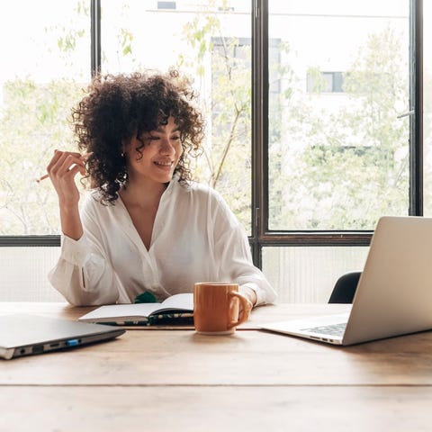 A person studies on a laptop computer at home.
