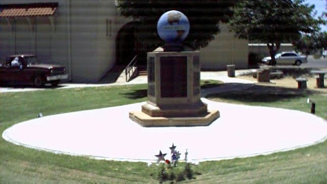 A monument to veterans stands in front of the Gilbert Historical Museum.