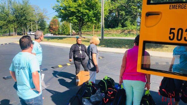 Members with The Pointe Church in Belmont will giveaway food boxes for the next several weeks on Thursday, In this file photograph members of the church are giving out bookbags..