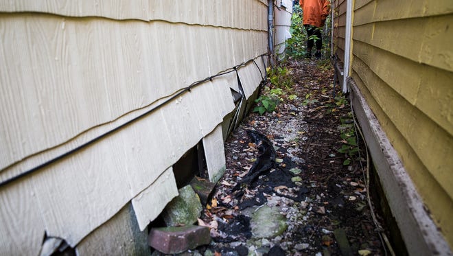 Holes in the foundation and siding allow rodents and wildlife to access 216 N. Vine St.
