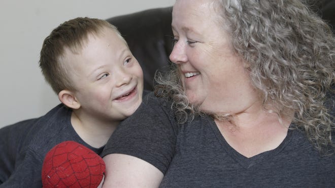 Denise Watts sits with her 6-year-old son Steven at their home in Middletown. Watts filed a lawsuit Monday alleging the local YMCA discriminated against her son because he has Down syndrome.