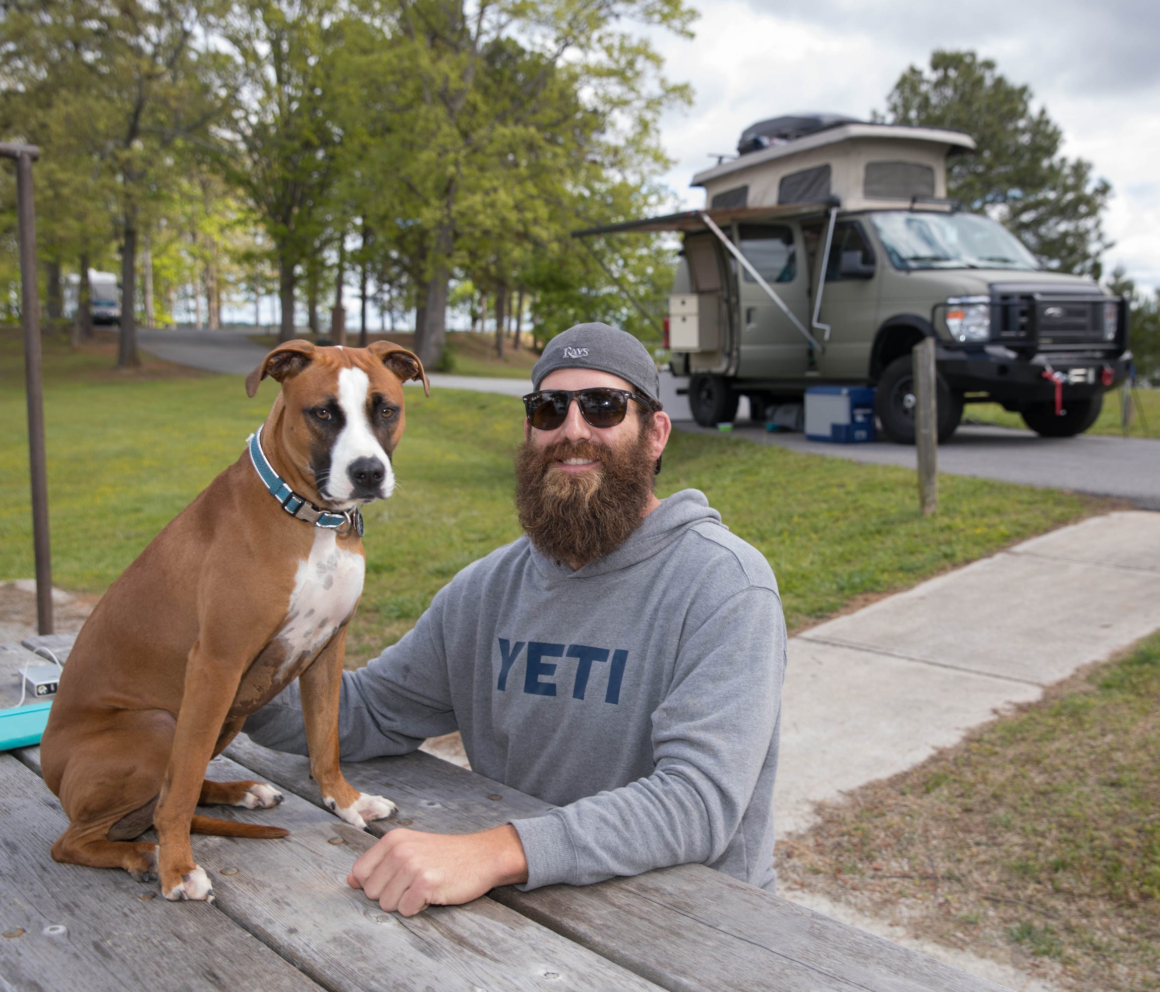 Joe Hawley poses with his 2-year-old boxer-mix Freedom in front of his tricked-out van at the Old Federal Campground on Lake Lanier in Flowery Branch, Ga.