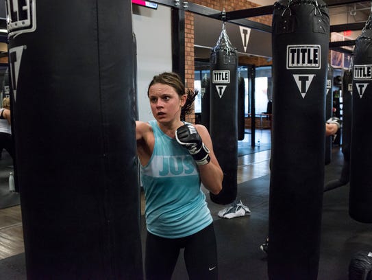 Madison Henry, 23, of Ann Arbor, works out during her class at the Title Boxing Club in Ann Arbor.