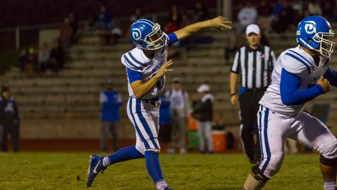Dixie quarterback Jacob Barben (13) throws a pass for a touchdown during Thursday's game against Cedar, October 19, 2017, in Cedar City, Utah.