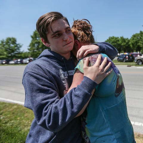 Sophomore Austin Duncan hugs his mom, Tina, near...