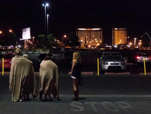 A group of women wait for their ride outside the Thomas