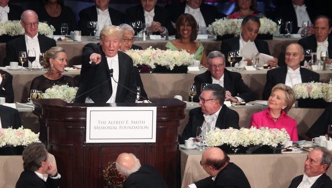 Trump, Clinton try for laughs at awkward Al Smith dinner