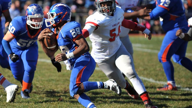 Vineland's Anthony Reyes (54) goes for a tackle against Millville's Clayton Scott in last year's Thanksgiving Day game. Reyes played the game despite injuries to his lower leg and ankle.