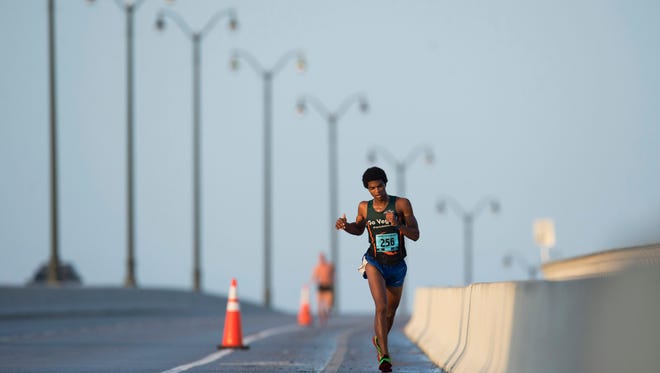 Second place finisher Jordan Garman, of Jacksonville, runs over the Stuart Causeway Bridge in 2015 as he competes in the Marathon of the Treasure Coast in Stuart.