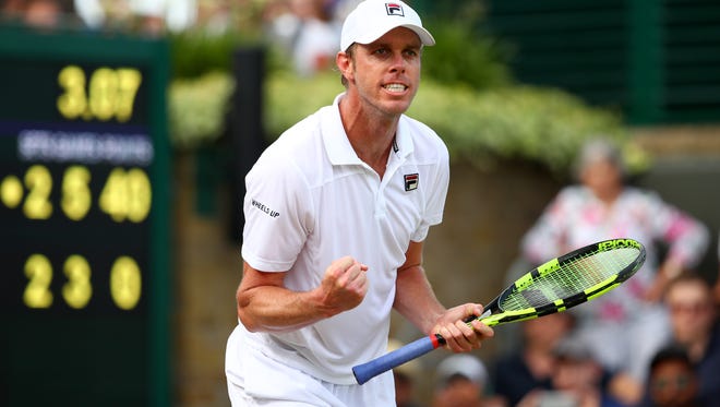 Thousand Oaks High graduate Sam Querrey celebrates after beating Kevin Anderson on Monday to reach the quarterfinal round at Wimbledon.