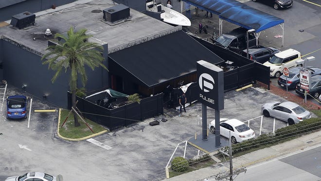 Law enforcement officers work the scene at the Pulse  nightclub June 12, 2016, in Orlando, following  a mass shooting.