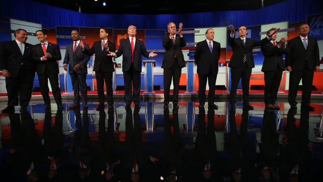 Republican presidential candidates from left, Chris Christie, Marco Rubio, Ben Carson, Scott Walker, Donald Trump, Jeb Bush, Mike Huckabee, Ted Cruz, Rand Paul, and John Kasich take the stage for the first Republican presidential debate at the Quicken Loans Arena Thursday, Aug. 6, 2015, in Cleveland. (AP Photo/Andrew Harnik)