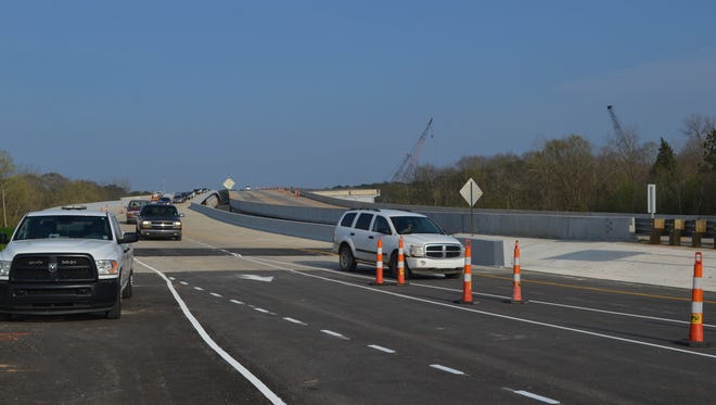 The first vehicles arrive in Alexandria from Pineville using the just-opened southbound span of the Curtis-Coleman Memorial Bridge over the Red River. The southbound span opened to traffic at 5:42 p.m. Tuesday, nearly one year after the northbound span opened to two-way traffic.