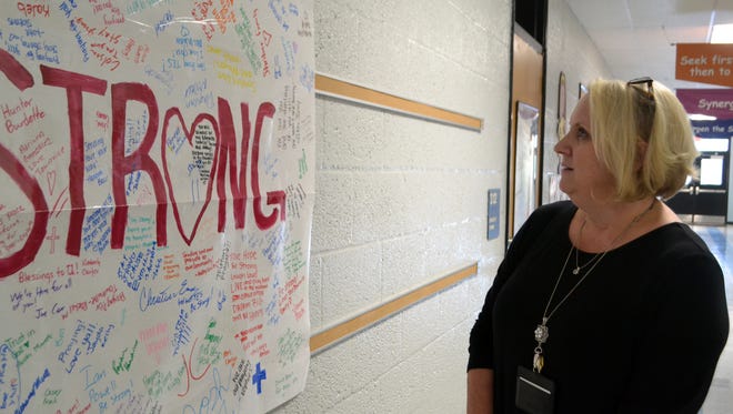 Townville Elementary School Principal Denise Fredericks looks for names of her former Townville students on a poster made by Pendleton High School. 